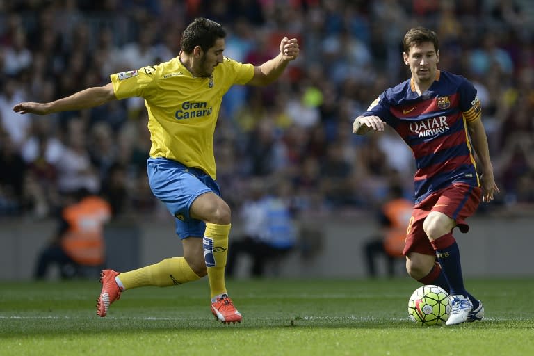 Las Palmas' defender Pedro Bigas Rigo (L) vies with Barcelona's Argentinian forward Lionel Messi during the Spanish league football match FC Barcelona vs UD Las Palmas at the Camp Nou stadium in Barcelona on September 26, 2015