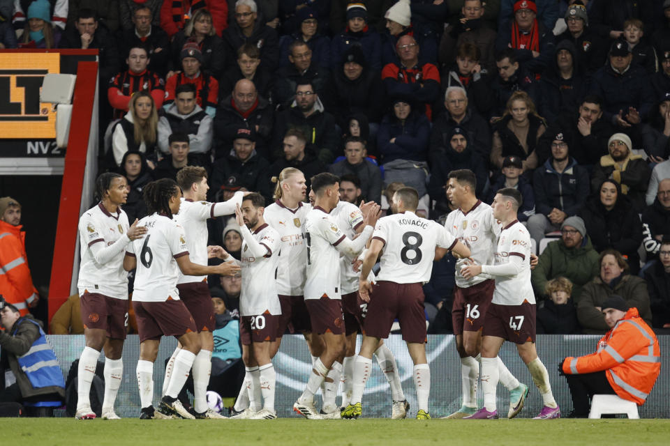 Manchester City's Phil Foden, right, is congratulated after scoring his side's opening goal during the English Premier League soccer match between Bournemouth and Manchester City at the Vitality stadium in Bournemouth, England, Saturday, Feb. 24, 2024. (AP Photo/David Cliff)