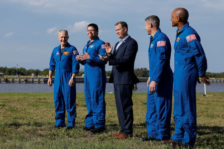 NASA commercial crew astronauts Doug Hurley, Bob Behnken, Mike Hopkins and Victor Glover stand with NASA Administrator Jim Bridenstine before the launch of a SpaceX Falcon 9 carrying the Crew Dragon spacecraft on an uncrewed test flight to the International Space Station from the Kennedy Space Center in Cape Canaveral, Florida, U.S., March 1, 2019. REUTERS/Mike Blake