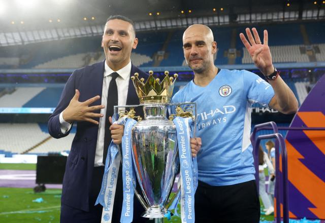 Manchester City chairman Khaldoon Al Mubarak and manager Pep Guardiola celebrate with the trophy after winning the Premier League in 2022 (REUTERS)