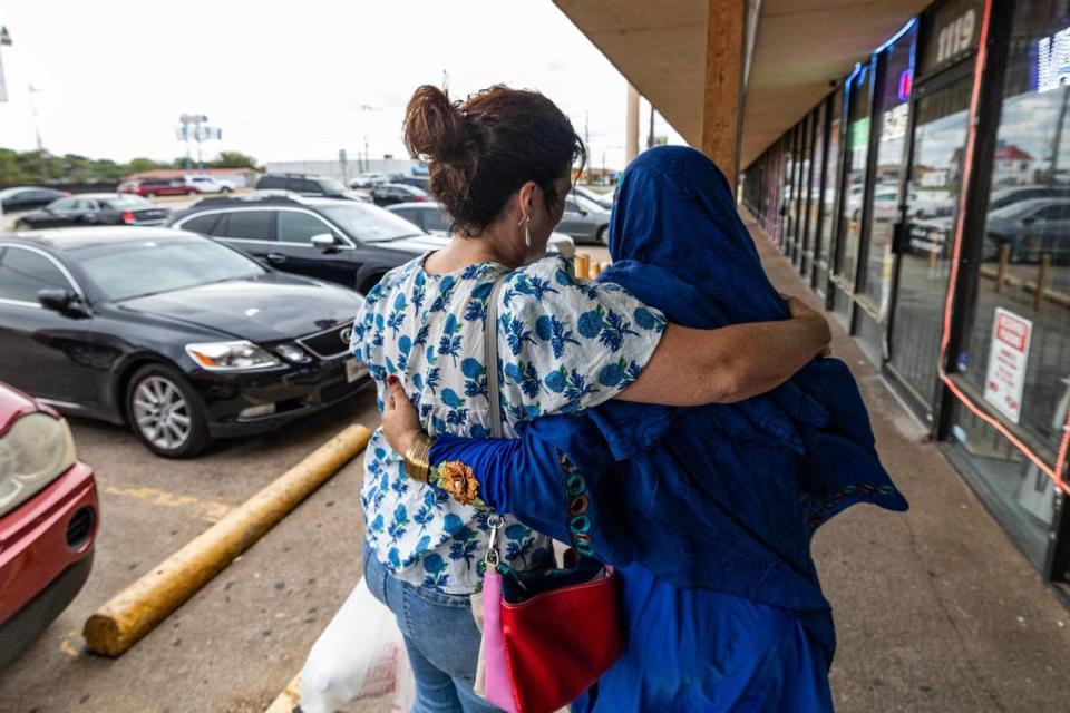 Angie Kraus, the founder of nonprofit Amshera, hugs Khatima Amini after getting groceries together at the Afghan Halal Market in Fort Worth. Kraus volunteers her time and money to assist Afghan refugees starting their new life in Fort Worth after they fled the country following the Taliban takeover in 2021.