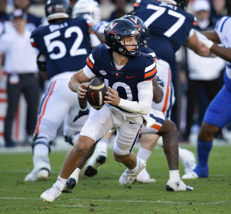 Virginia quarterback Anthony Colandrea (10) runs out of the pocket to avoid the Duke defense during the first half of an NCAA college football game Saturday, Nov. 18, 2023, in Charlottesville, Va. (AP Photo/Mike Caudill)