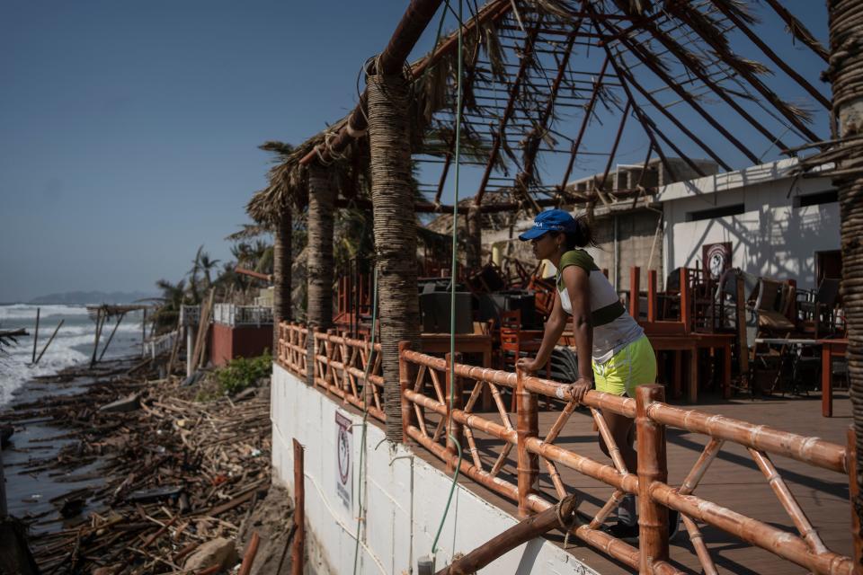 A woman stands at a damaged area in the aftermath of Hurricane Otis in Acapulco, Mexico, Sunday, Oct. 29, 2023. Mexican authorities have raised the toll to 48 dead from the Category 5 storm that struck the country's southern Pacific coast.