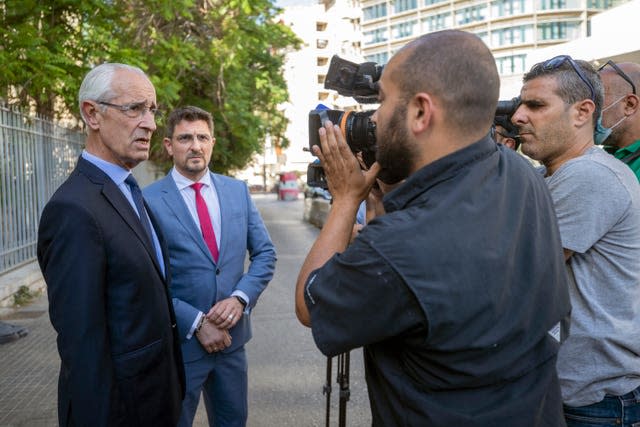 Jean Yves Le Borgne, left, speaks with journalists outside the Justice Palace in Beirut, Lebanon