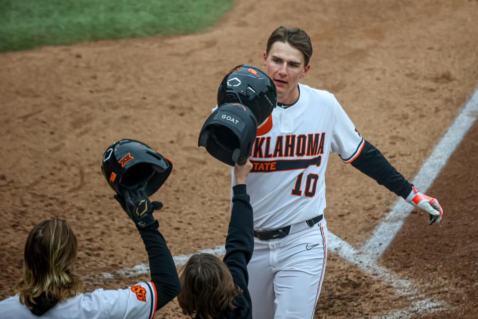 Oklahoma State's Nolan Schubart crosses home plate after hitting a home run against Loyola Marymount at O’Brate Stadium in Stillwater on Saturday.