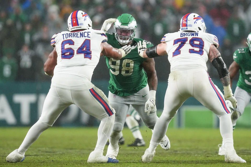 PHILADELPHIA, PENNSYLVANIA – NOVEMBER 26: O’Cyrus Torrence #64 of the <a class="link " href="https://sports.yahoo.com/nfl/teams/buffalo/" data-i13n="sec:content-canvas;subsec:anchor_text;elm:context_link" data-ylk="slk:Buffalo Bills;sec:content-canvas;subsec:anchor_text;elm:context_link;itc:0">Buffalo Bills</a> and <a class="link " href="https://sports.yahoo.com/nfl/players/33481" data-i13n="sec:content-canvas;subsec:anchor_text;elm:context_link" data-ylk="slk:Spencer Brown;sec:content-canvas;subsec:anchor_text;elm:context_link;itc:0">Spencer Brown</a> #79 of the Buffalo Bills block <a class="link " href="https://sports.yahoo.com/nfl/players/40035" data-i13n="sec:content-canvas;subsec:anchor_text;elm:context_link" data-ylk="slk:Jalen Carter;sec:content-canvas;subsec:anchor_text;elm:context_link;itc:0">Jalen Carter</a> #98 of the Philadelphia Eagles during the second quarter at Lincoln Financial Field on November 26, 2023 in Philadelphia, Pennsylvania. (Photo by Mitchell Leff/Getty Images)