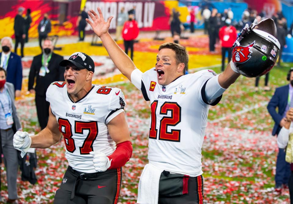 Tampa Bay Buccaneers quarterback Tom Brady (12) and tight end Rob Gronkowski (87) celebrate after beating the Kansas City Chiefs in Super Bowl LV at Raymond James Stadium.