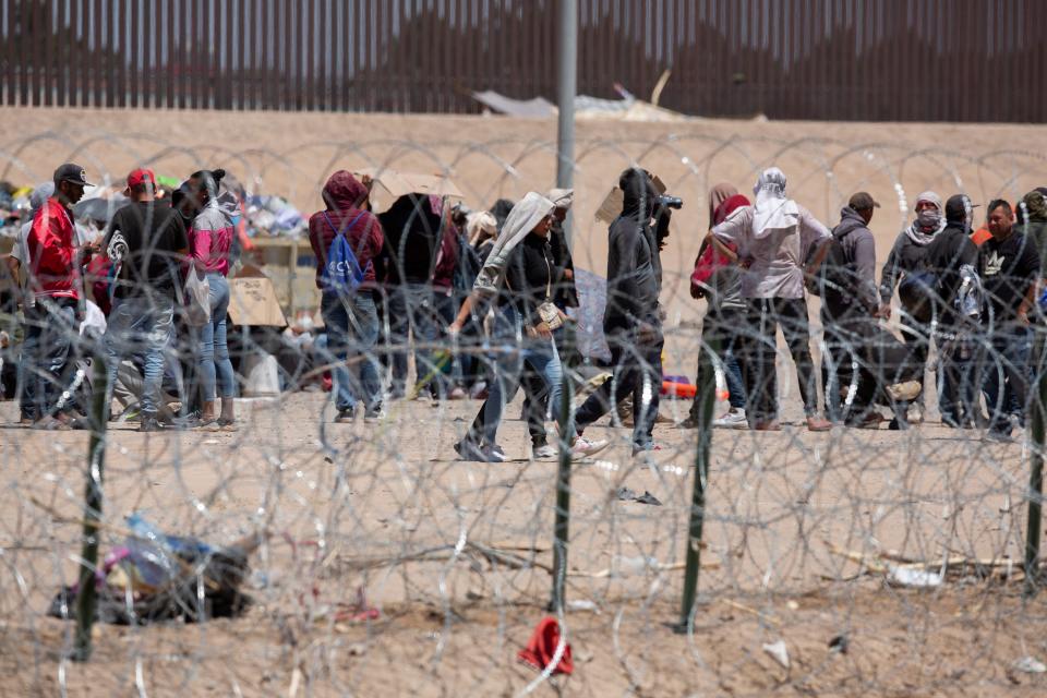 Migrants wait to be processed at gate 40 of the border wall after having crossed the Rio Grande from Ciudad Juarez in hopes of turning themselves in with the intention of seeking asylum.