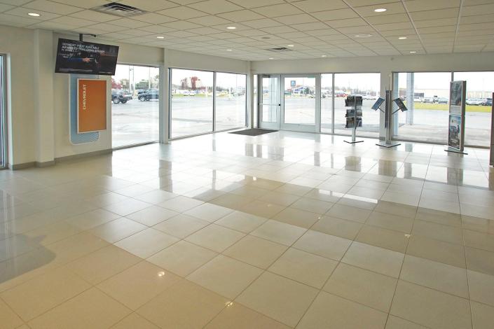 An empty showroom at Greg Bell Chevrolet-Cadillac, 1313 U.S. 223 in Adrian, looks out on an empty sales lot Wednesday. Due to a microchip shortage, new vehicles are on back order anywhere from six weeks to six months, but local dealerships are taking it all in stride.