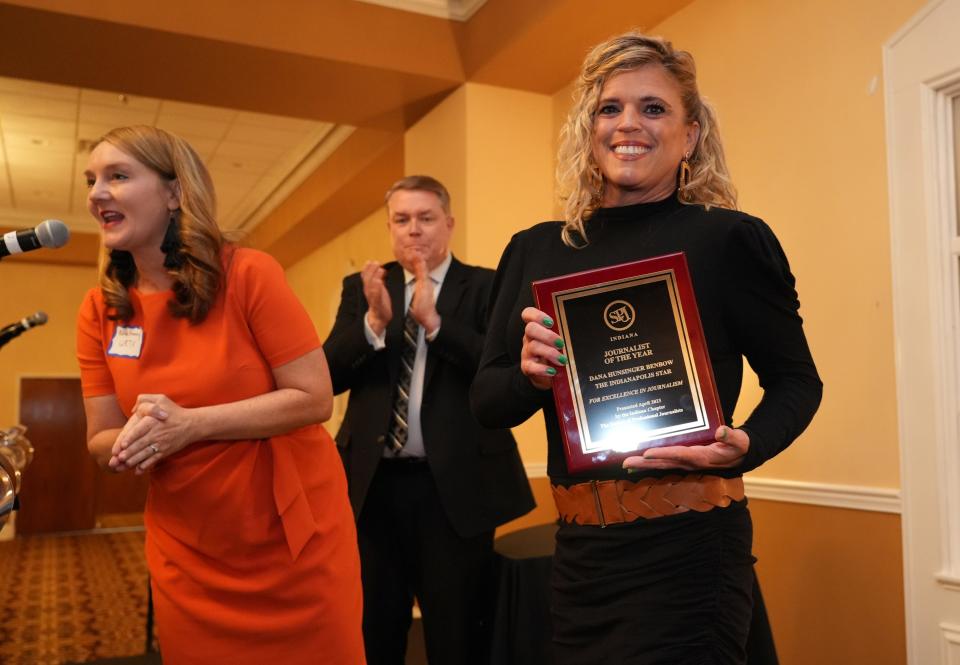 Kara Kenny (left), Indiana SPJ secretary, presents the award for Journalist of the Year to IndyStar reporter Dana Hunsinger Benbow. 