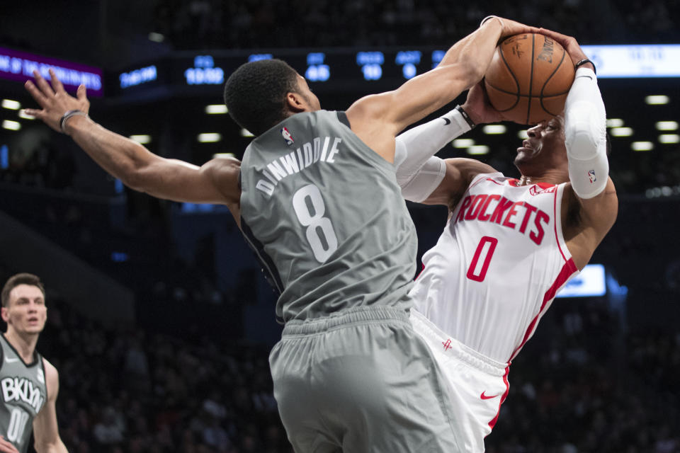 Brooklyn Nets guard Spencer Dinwiddie (8) guards Houston Rockets guard Russell Westbrook (0) during the first half of an NBA basketball game Friday, Nov. 1, 2019, in New York. (AP Photo/Mary Altaffer)