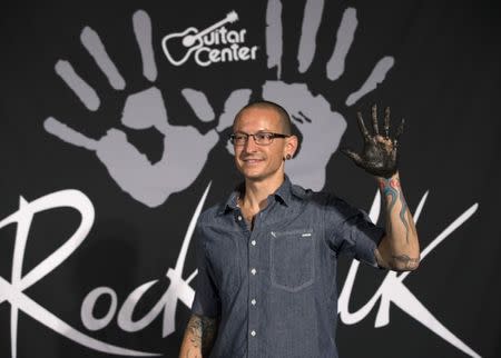 Lead vocalist of rock band Linkin Park Chester Bennington shows his hand covered in cement as the band is inducted into Guitar Center's RockWalk in Los Angeles, California June 18, 2014. REUTERS/Mario Anzuoni