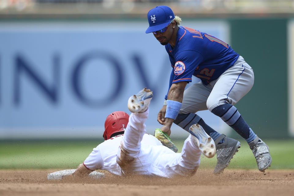 Washington Nationals' Trea Turner, bottom, steals second against New York Mets shortstop Francisco Lindor, top, during the third inning of a baseball game, Sunday, June 20, 2021, in Washington. (AP Photo/Nick Wass)