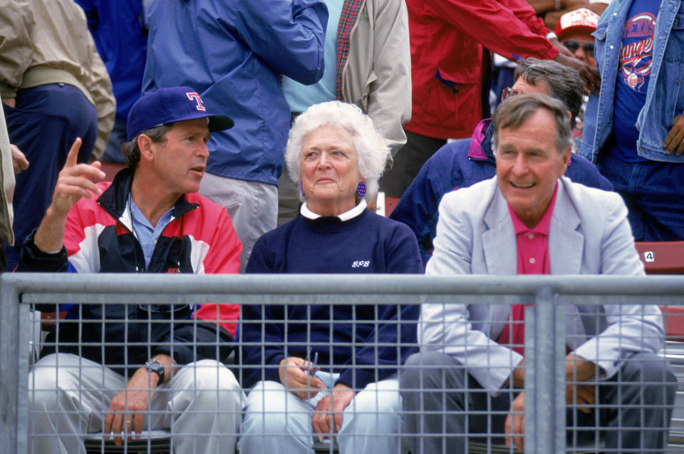 Co-owner and managing general partner of the Texas Rangers George W. Bush (left) sits with his father&nbsp;and mother, as they attend a Texas Rangers game in Arlington, Texas, in the 1990s.