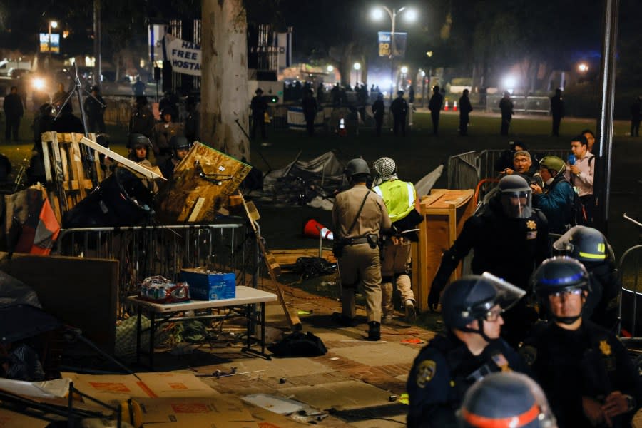 Police make an arrest as they face-off with pro-Palestinian students after destroying part of the encampment barricade on the campus of the University of California, Los Angeles (UCLA) in Los Angeles, California, early on May 2, 2024. (Photo by ETIENNE LAURENT/AFP via Getty Images)