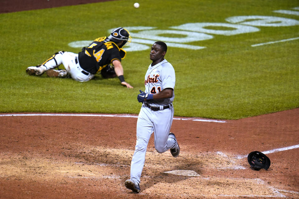 Detroit Tigers' Daz Cameron (41) scores on a double by Tucker Barnhart as Pittsburgh Pirates catcher Tyler Heineman is unable to handle the offline relay throw during the eighth inning of a baseball game in Pittsburgh, Tuesday, June 7, 2022. (AP Photo/Gene J. Puskar)