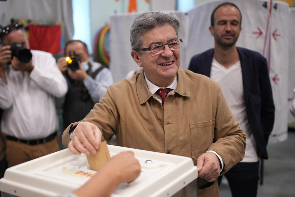 Hard-left figure Jean-Luc Melenchon casts his ballot in the first round of the parliamentary election, Sunday, June 12, 2022 in Marseille, southern France. French voters are choosing lawmakers in a parliamentary election as President Emmanuel Macron seeks to secure his majority while under growing threat from a leftist coalition. (AP Photo/Daniel Cole)