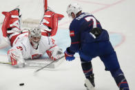 Poland's goalkeeper John Murray, left, makes a save in front of Unted States' Brady Tkachuk during the preliminary round match between Poland and United States at the Ice Hockey World Championships in Ostrava, Czech Republic, Friday, May 17, 2024. (AP Photo/Darko Vojinovic)