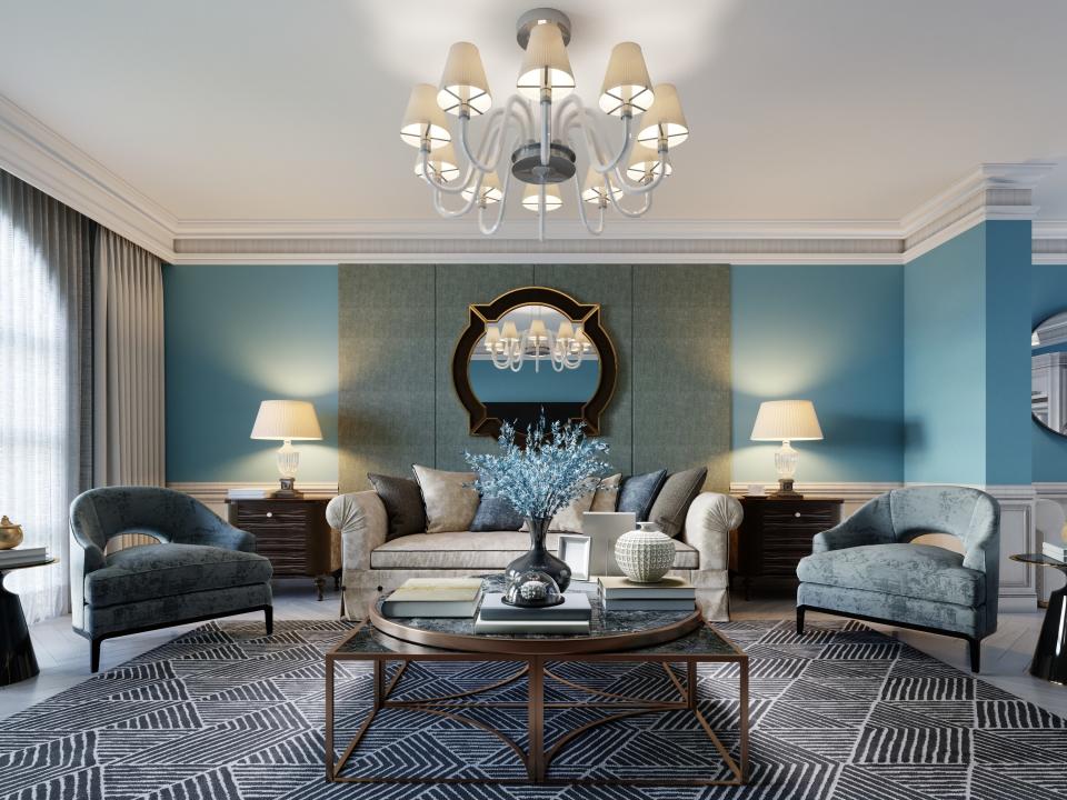 Traditional looking living room with blue accents and ornate light fixtures and decorations