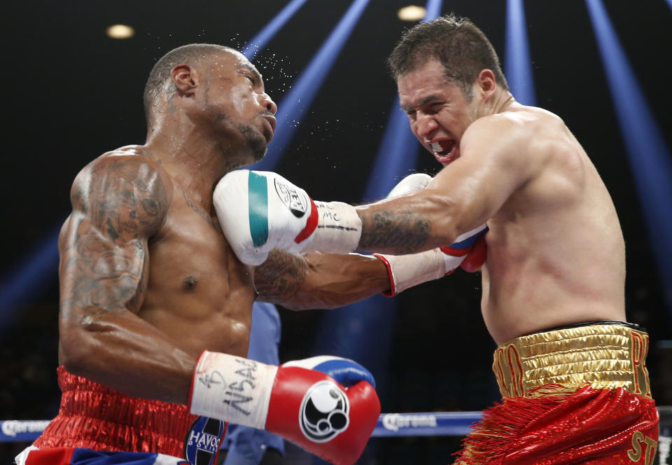 Marco Periban, right, from Mexico, and J'Leon Love, from Las Vegas, trade blows in their WBA super middleweight title boxing fight Saturday, May 3, 2014, in Las Vegas. (AP Photo/Eric Jamison)