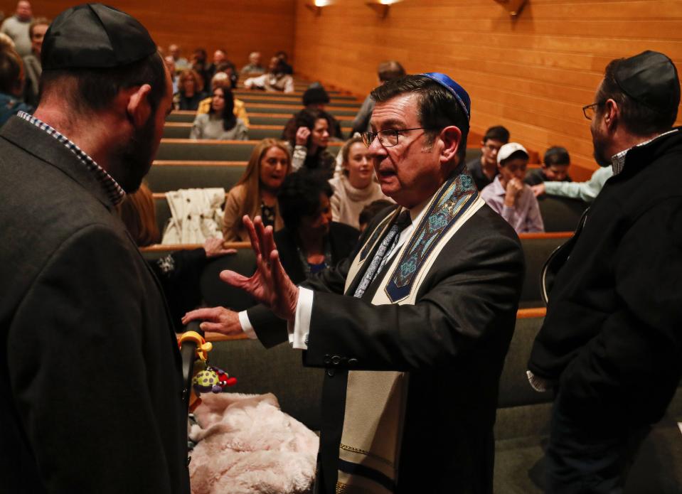 Senior Rabbi Dr. Dennis C. Sasso talks with Josh Vela while Indianapolis residents gather to show solidarity with the Jewish community at the Congregation Beth-El Zedeck on Jan. 3, 2020. This service was in response to the recent antisemetic attacks on the Jewish community in New York City.