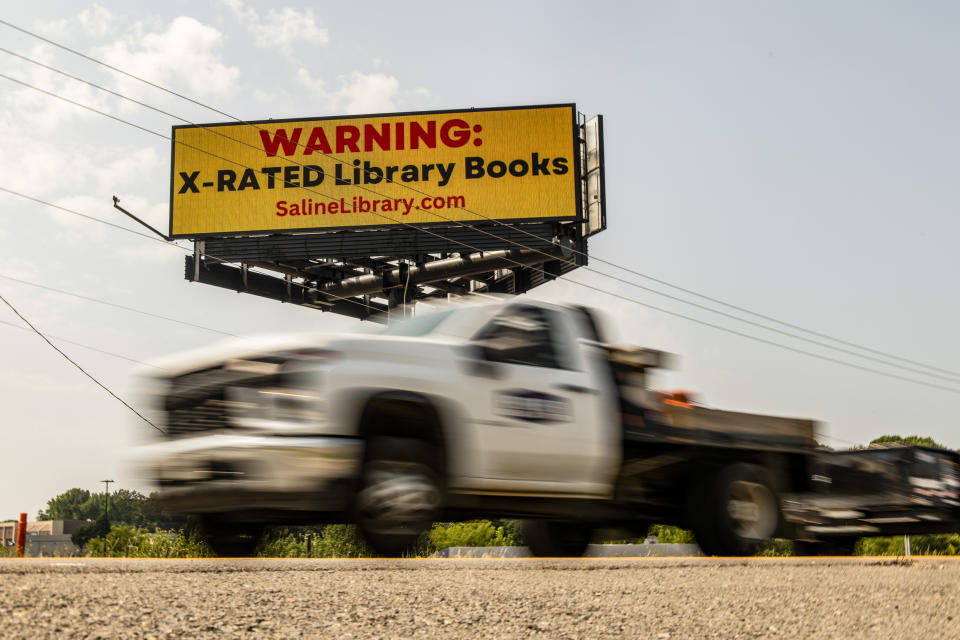 A billboard from a group challenging books in public libraries is seen near Benton, Ark., on May 25, 2023. (Brandon Dill for NBC News)