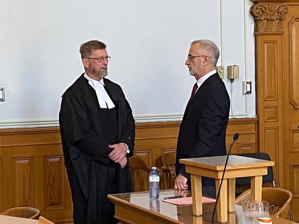 Regular, right, speaks with his defence counsel. Jerome Kennedy, before the verdict.