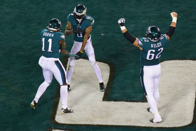 <p>AP</p> Philadelphia Eagles wide receiver DeVonta Smith (6) celebrates his touchdown with wide receiver A.J. Brown (11) and center Jason Kelce (62) during the NFL divisional round playoff football game against the New York Giants, Saturday, Jan. 21, 2023, in Philadelphia.