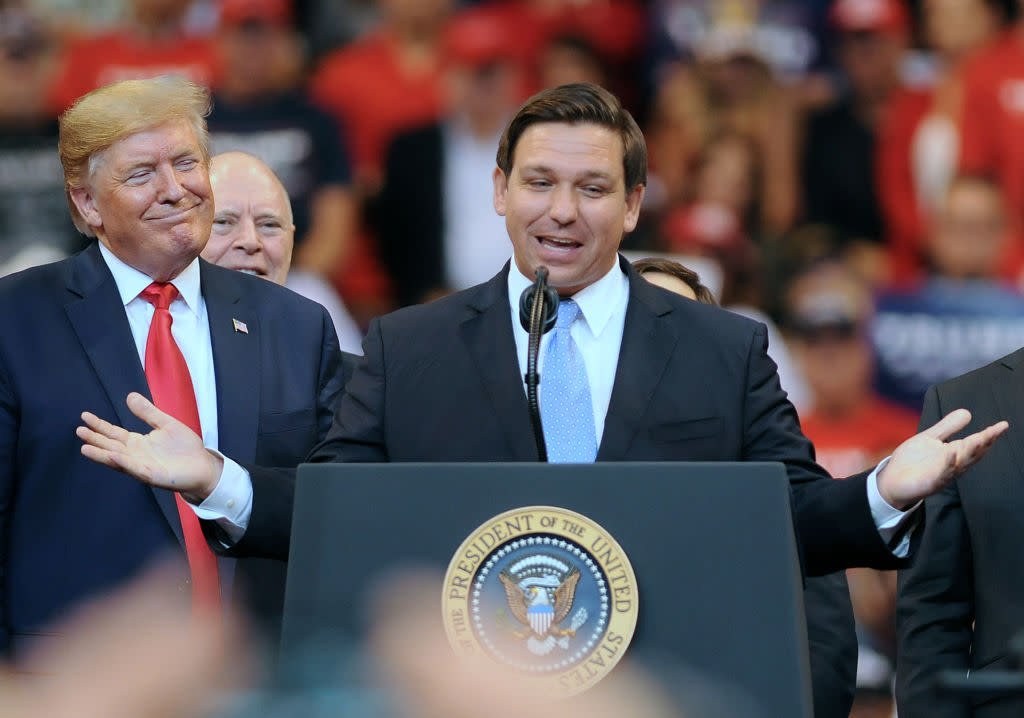 U.S. President Donald Trump looks on as Florida Governor Ron