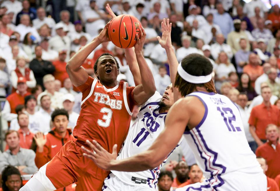 Feb 3, 2024; Fort Worth, Texas, USA;  Texas Longhorns guard Max Abmas (3) shoots as TCU Horned Frogs guard Trevian Tennyson (11) and TCU Horned Frogs forward Xavier Cork (12) defend during the second half at Ed and Rae Schollmaier Arena. Mandatory Credit: Kevin Jairaj-USA TODAY Sports