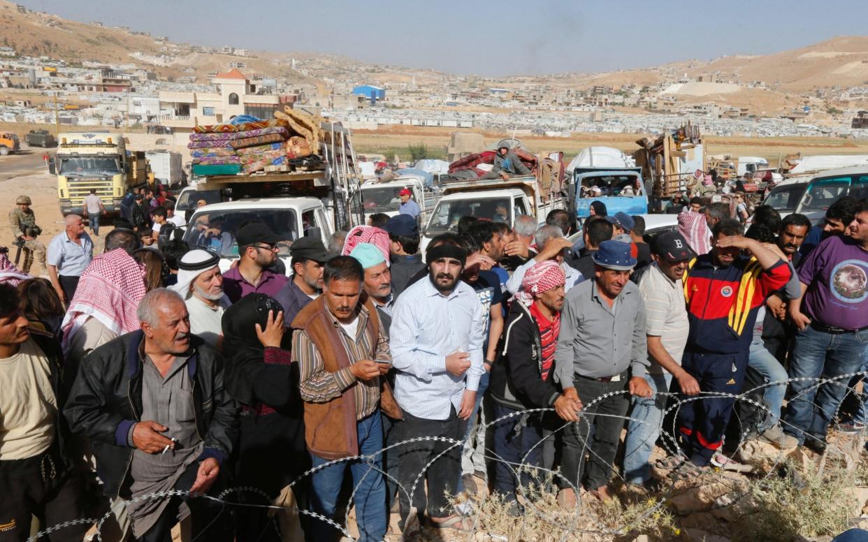 Syrian refugees prepare to return to Syria from the Lebanese border town of Arsal - REUTERS