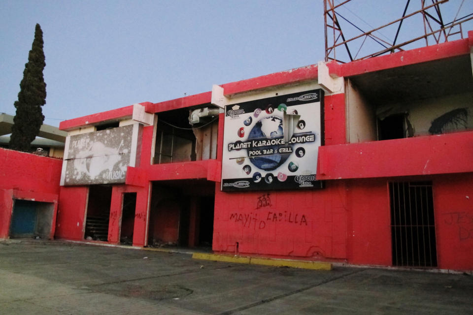 This Friday, Feb. 28, 2014, photo shows a gutted and abandoned building that once housed the Planet Music Lounge in Matamoros, Mexico. In the midst of a three-year increase in American tourism in Mexico, communities along the Rio Grande are trying to win back U.S. tourists and revitalize their tourism industry. (AP Photo/Olga Rodriguez)