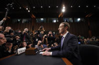 FILE - In this April 10, 2018, file photo, Facebook CEO Mark Zuckerberg takes his seat to testify before a joint hearing of the Commerce and Judiciary Committees on Capitol Hill in Washington. Reports of hateful and violent speech on Facebook poured in on the night of May 28 after President Donald Trump hit send on a social media post warning that looters who joined protests following Floyd's death last year would be shot, according to internal Facebook documents shared with The Associated Press. (AP Photo/Alex Brandon, File)