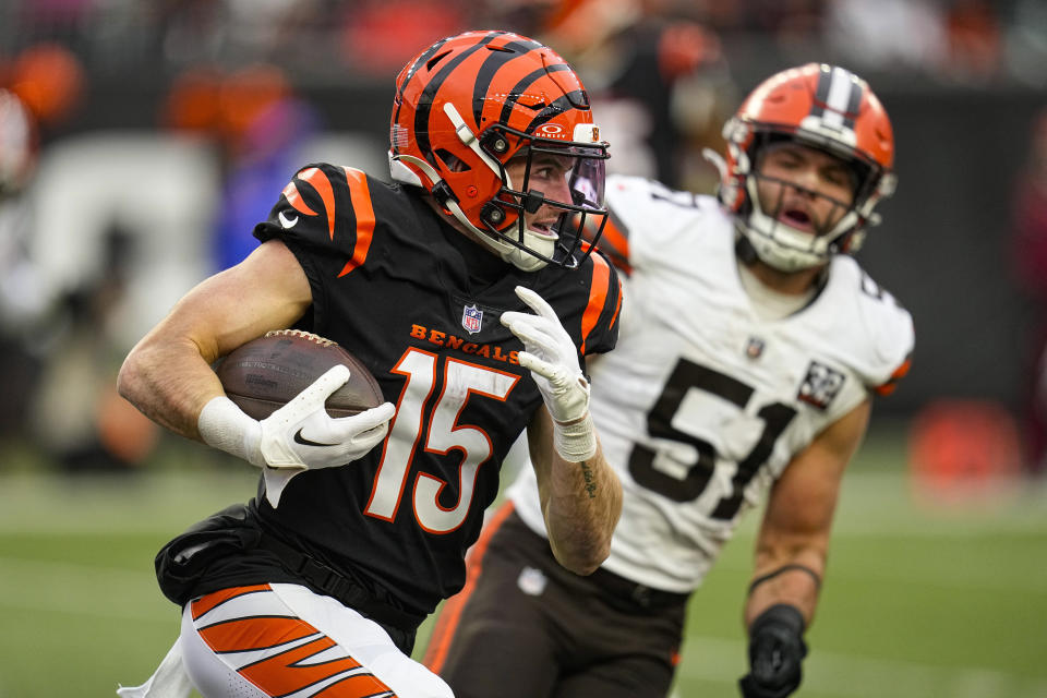 Cincinnati Bengals wide receiver Charlie Jones (15) tries to get past Cleveland Browns linebacker Jordan Kunaszyk (51) in the second half of an NFL football game in Cincinnati, Sunday, Jan. 7, 2024. (AP Photo/Sue Ogrocki)