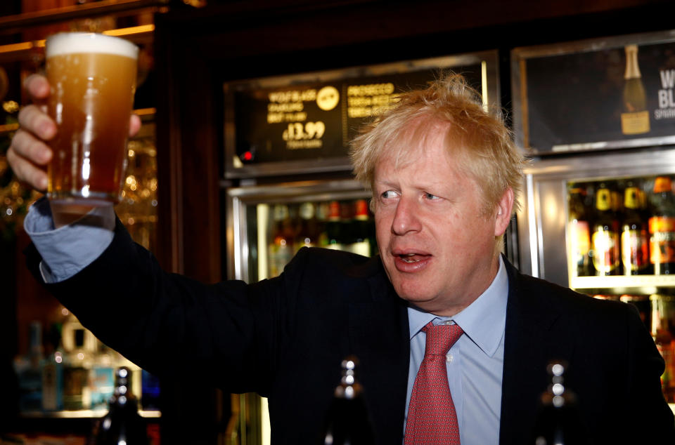 LONON, ENGLAND - JULY 10: Boris Johnson, a leadership candidate for Britain's Conservative Party holds a pint of beer as he meets with JD Wetherspoon chairman, Tim Martin at  Wetherspoons Metropolitan Bar on July 10, 2019 in London, England. (Photo by Henry Nicholls WPA Pool/Getty Images)