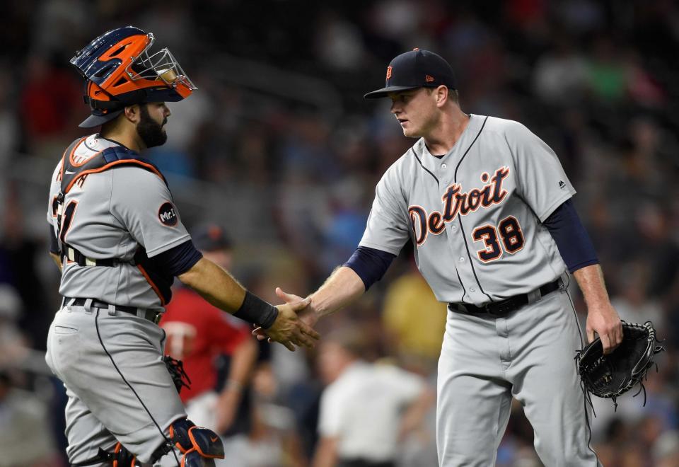 Alex Avila #31 and Justin Wilson #38 of the Detroit Tigers celebrate winning the game against the Minnesota Twins on July 21, 2017 at Target Field in Minneapolis, Minnesota. The Tigers defeated the Twins 6-3.