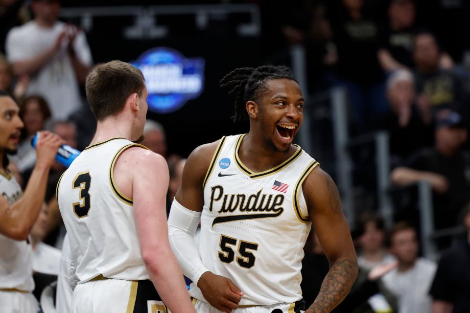 Purdue guard Lance Jones (55) celebrates with teammate Braden Smith during the Midwest Regional championship game of the NCAA men's tournament at Little Caesars Arena.