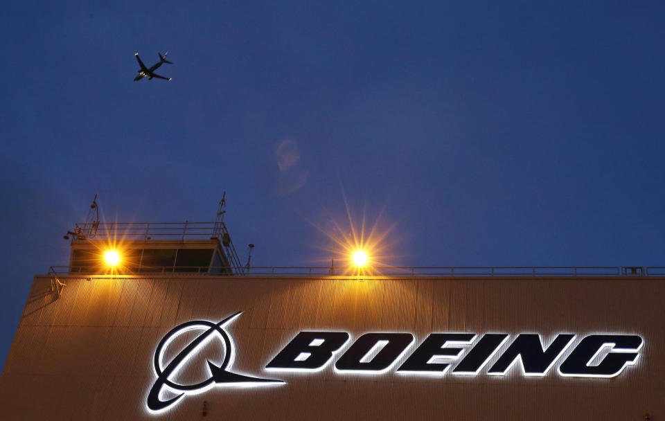 FILE - An airplane flies over a sign on Boeing's 737 delivery center, Oct. 19, 2015, at Boeing Field in Seattle. Boeing will be in the spotlight during back-to-back hearings Wednesday, April 17, 2024, as Congress examines allegations of major safety failures at the embattled aircraft manufacturer. (AP Photo/Ted S. Warren, File)