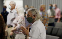 Pastor Denny Pagel prays during a service at Grace Bible Church on Sunday, May 24, 2020, in Tempe, Ariz. Parishioners practiced social distancing as the church held its first in-person service since March. (AP Photo/Ross D. Franklin)