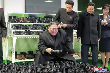 FILE PHOTO: North Korean leader Kim Jong Un visits a shoe factory in Wonsan