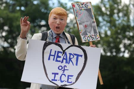 A demonstrator dressed as U.S. President Donald Trump marches as immigration activists rally as part of a march calling for "an end to family detention" and in opposition to the immigration policies of the Trump administration, in Washington, U.S., June 28, 2018. REUTERS/Jonathan Ernst