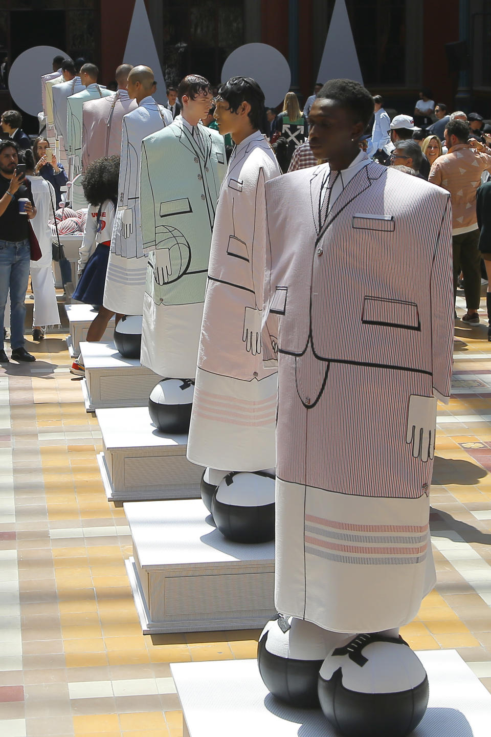 Guests take pictures of model at the Thom Browne mens Spring-Summer 2020 fashion collection presented in Paris, Saturday, June 22 2019. (AP Photo/Michel Euler)