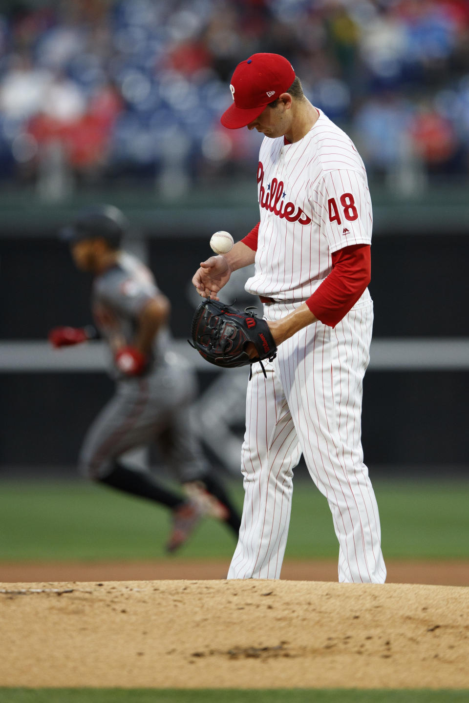 Philadelphia Phillies starting pitcher Jerad Eickhoff juggles a fresh baseball after giving up a home run to Arizona Diamondbacks' Ketel Marte during the first inning of a game, Monday, June 10, 2019, in Philadelphia. (AP Photo/Matt Slocum)