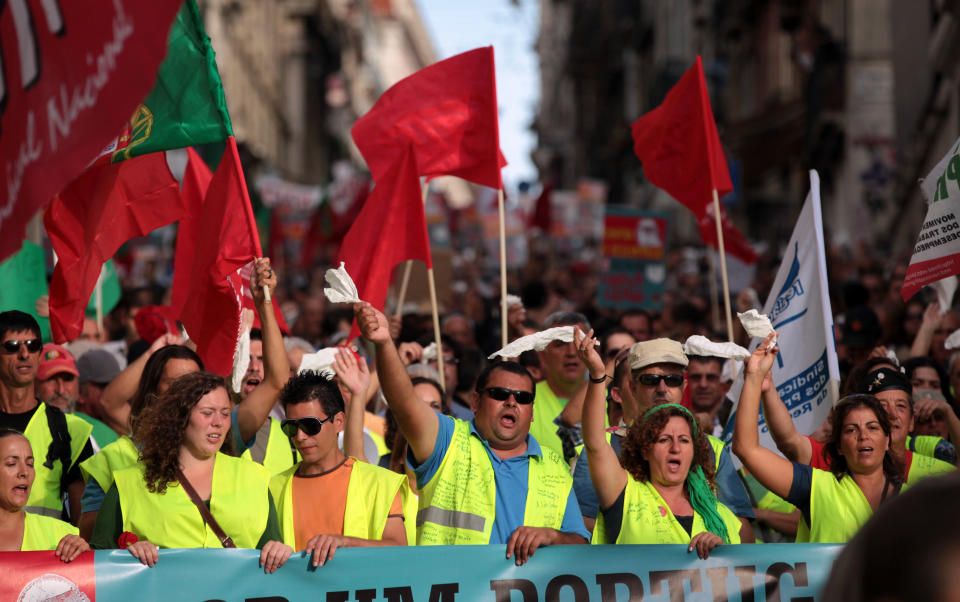Demonstrators wave white tissues while demanding the government resignation during a protest march against unemployment heading to the Portuguese parliament in Lisbon and organized by workers' unions Saturday, Oct. 13 2012. Unemployment figures in Portugal have soared since the introduction of austerity measures to fight the country's debt crisis. (AP Photo/Armando Franca)