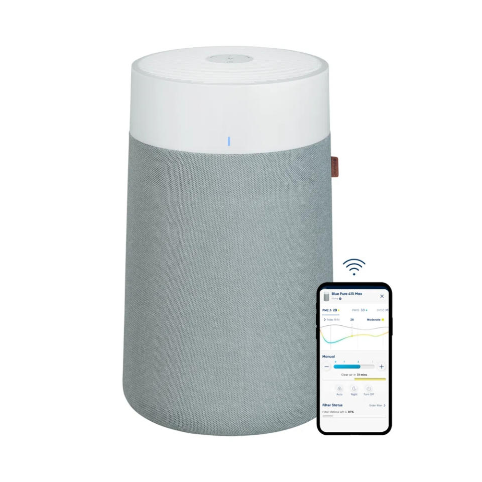 The cylindrical air purifier with a companion app displayed on a smartphone screen, showcasing filter status and control features