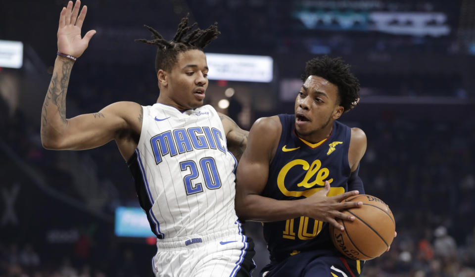 Cleveland Cavaliers' Darius Garland (10) drives past Orlando Magic's Markelle Fultz (20) in the first half of an NBA basketball game, Friday, Dec. 6, 2019, in Cleveland. (AP Photo/Tony Dejak)