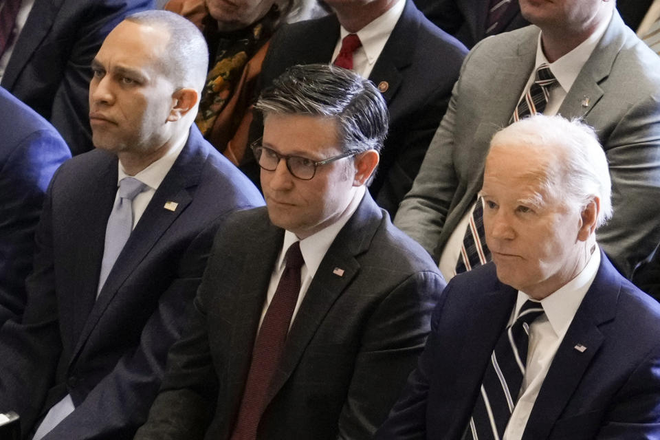 FILE - President Joe Biden, with from left, House Minority Leader Hakeem Jeffries, D-N.Y., and House Speaker Mike Johnson of La., listen during the National Prayer Breakfast, Thursday, Feb. 1, 2024, at the Capitol in Washington. The differences are vast between Johnson, a staunchly conservative Republican, and Jeffries, a hero to liberal Democrats. But at the prayer breakfast earlier this month, they collegially took turns reading Scripture — evoking how their shared Christianity confronts evil. (AP Photo/J. Scott Applewhite, File)