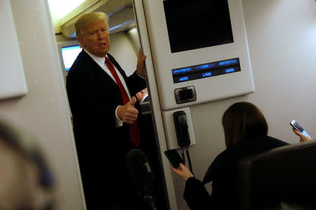 U.S. President Donald Trump speaks to reporters aboard Air Force One as they approach Joint Base Andrews, Maryland, U.S. March 15, 2017. REUTERS/Jonathan Ernst