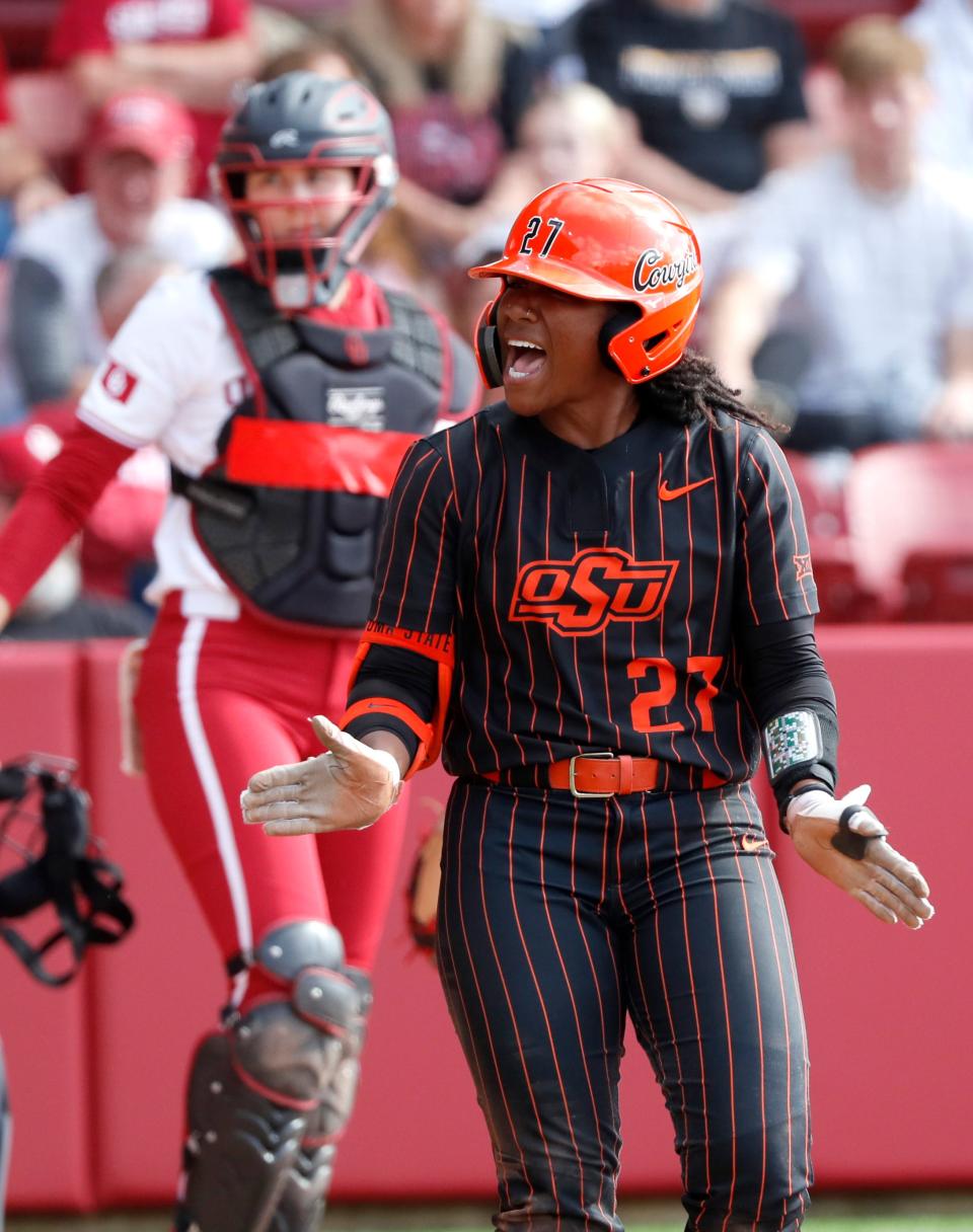 Oklahoma State's Jilyen Poullard (27) celebrates a walk in the seventh inning during the Bedlam college softball game between the University of Oklahoma Sooners and the Oklahoma State University Cowgirls at Love's Field in Norman, Okla., Sunday, May, 5, 2024.