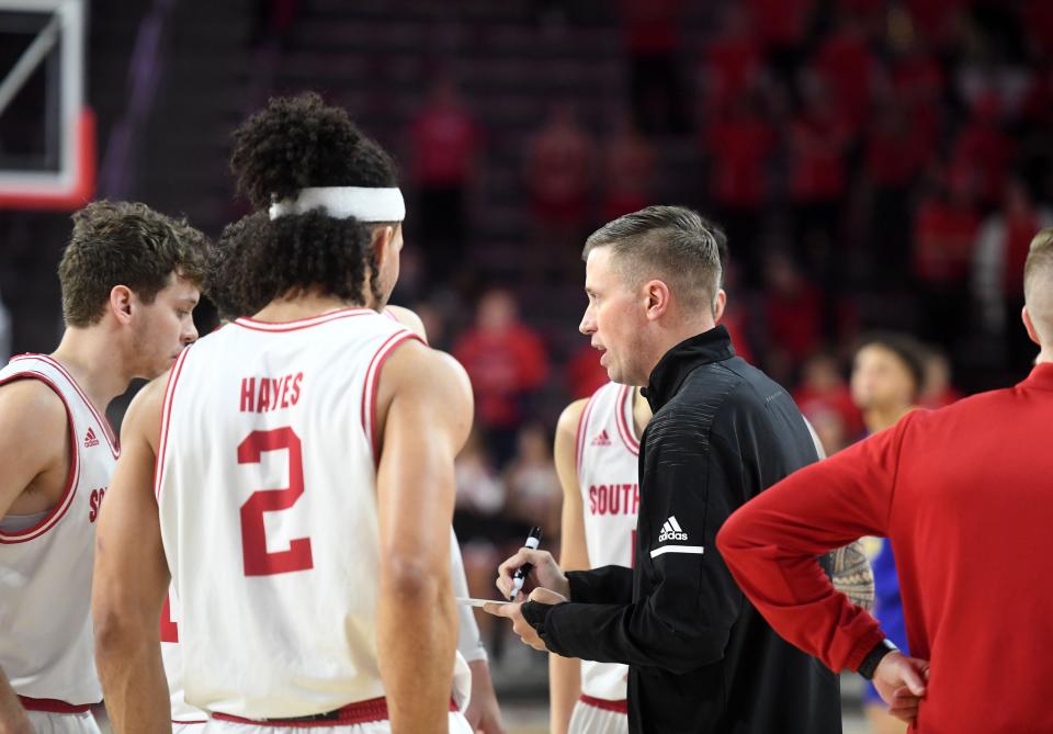 South Dakota head coach Eric Peterson returns to coaching, after recovering from an injury, on Saturday, January 14, 2023, at the Sanford Coyote Sports Center in Vermillion.